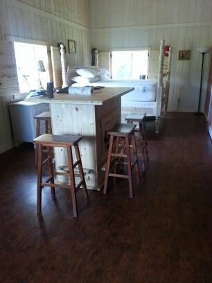Kitchen Island, with poster bed in background. 